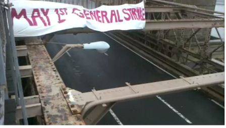 general strike banner drop on Brooklyn Bridge